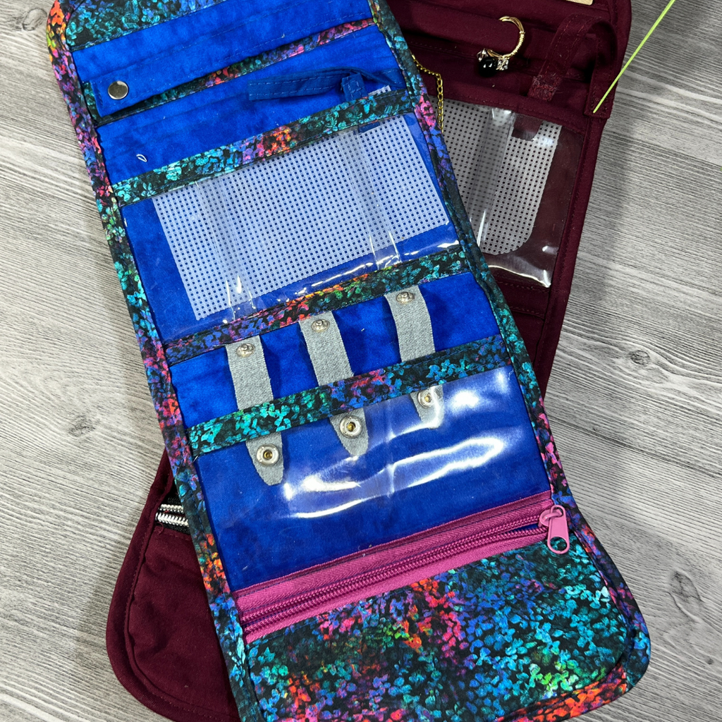 blue jewelry organizer open empty with gray tabs pink zipper pocket 