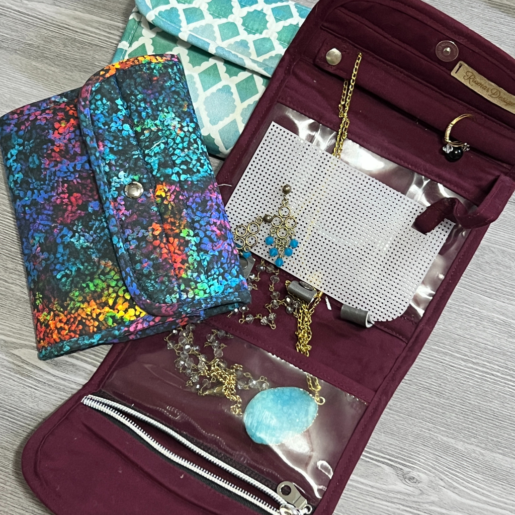 burgundy jewelry organizer open with ring and necklace. Closed jewelry organizer colorful